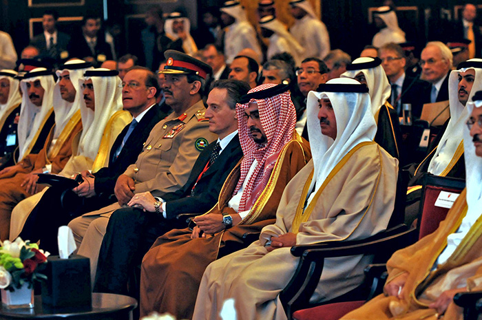 Prince du Bahreïn H.H. Sheikh Salman bin Hamad Al-Khalifa (droite), le secrétaire général délégué de l'OTAN Amb. Claudio Bisogniero (centre), chef d'état-major des forces armées bahreïnies Maj.Gen. Rashid bin Abdallah Al-Khalifa et le Secrétaire général adjoint pour la diplomatique publique Mr. Jean-Francois Bureau (gauche) sont assis côte à côté.
