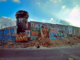 Mur de séparation entre Israël et territoire palestiniens avec le portrait d'Arafat