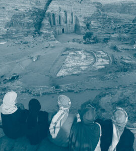 jeunes assis regardant les monuments de Pétra