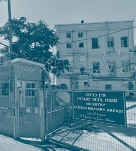 Tribunal militaire israélien à Jaffa avec des barbelés à l'entrée et un panneau qui indique la défense d'entrer