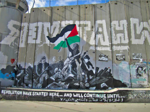 Murales sur le mur de séparation enter Israël et territoires palestiniens représentant 